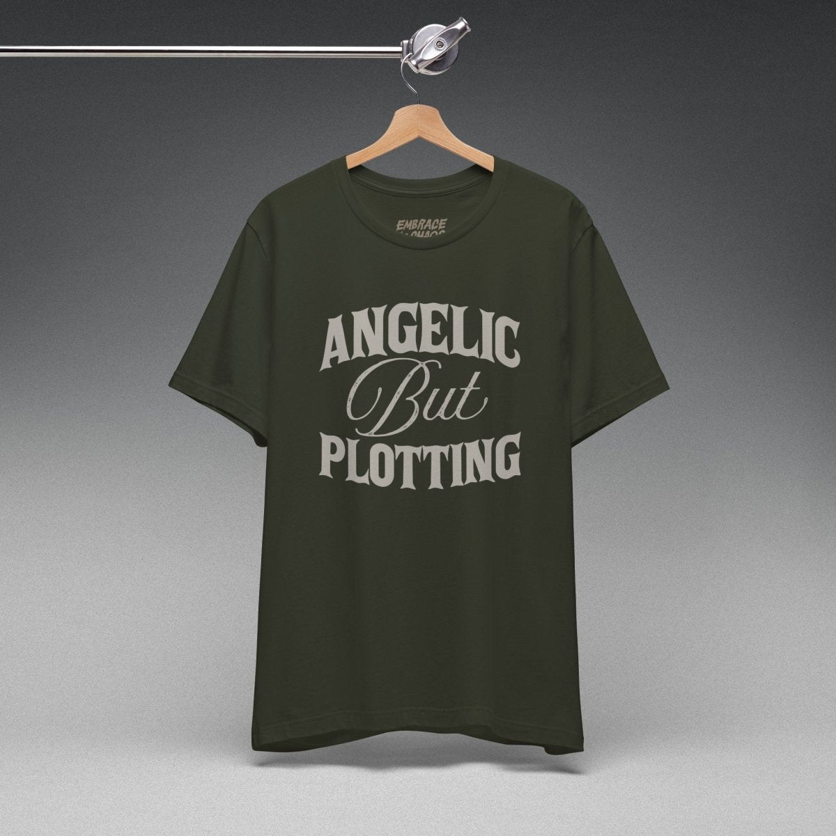 ANGELIC BUT PLOTTING TEE XS Dark Olive - Embrace The Chaos mental health humor apparel