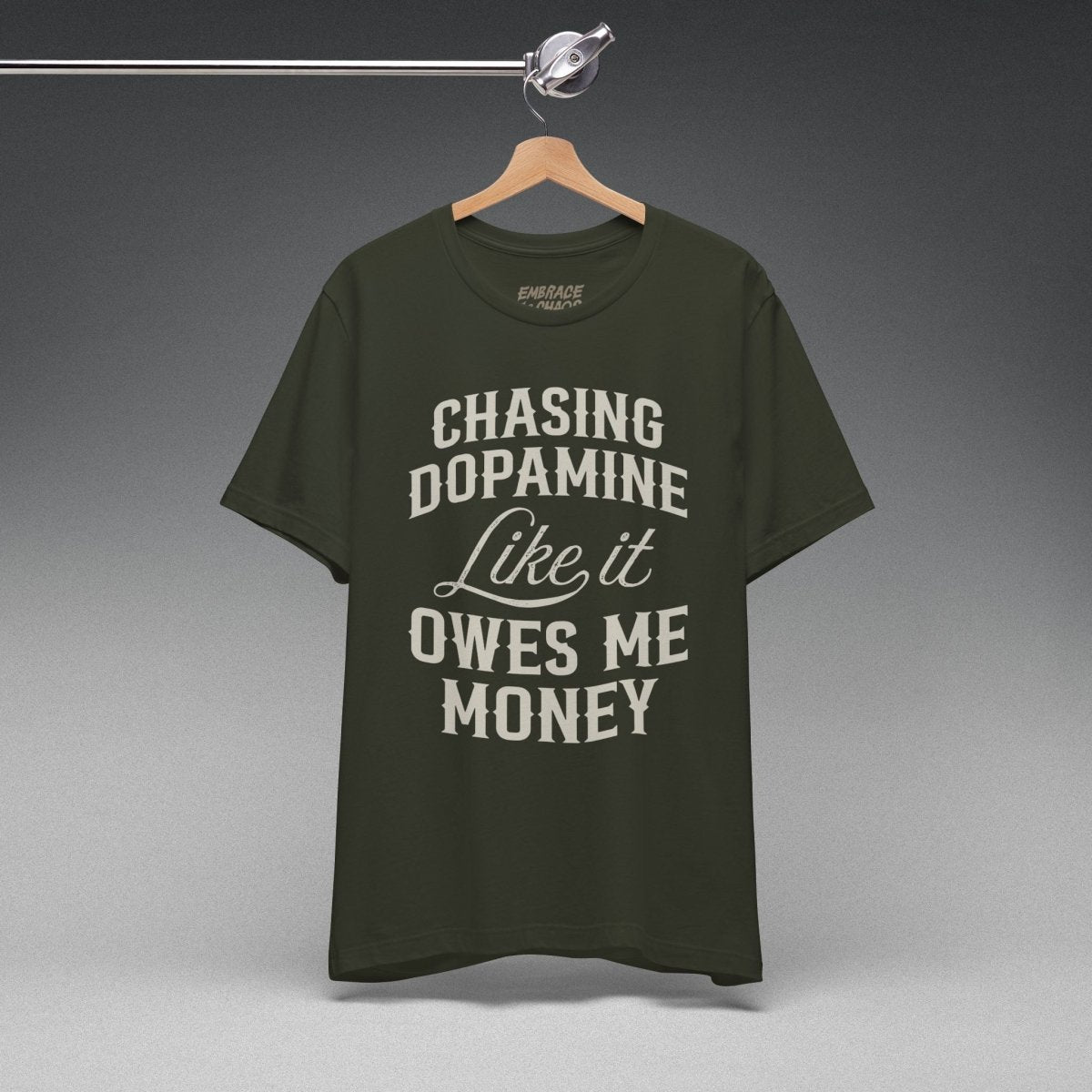 CHASING DOPAMINE LIKE IT OWES ME MONEY TEE XS Dark Olive - Embrace The Chaos mental health humor apparel