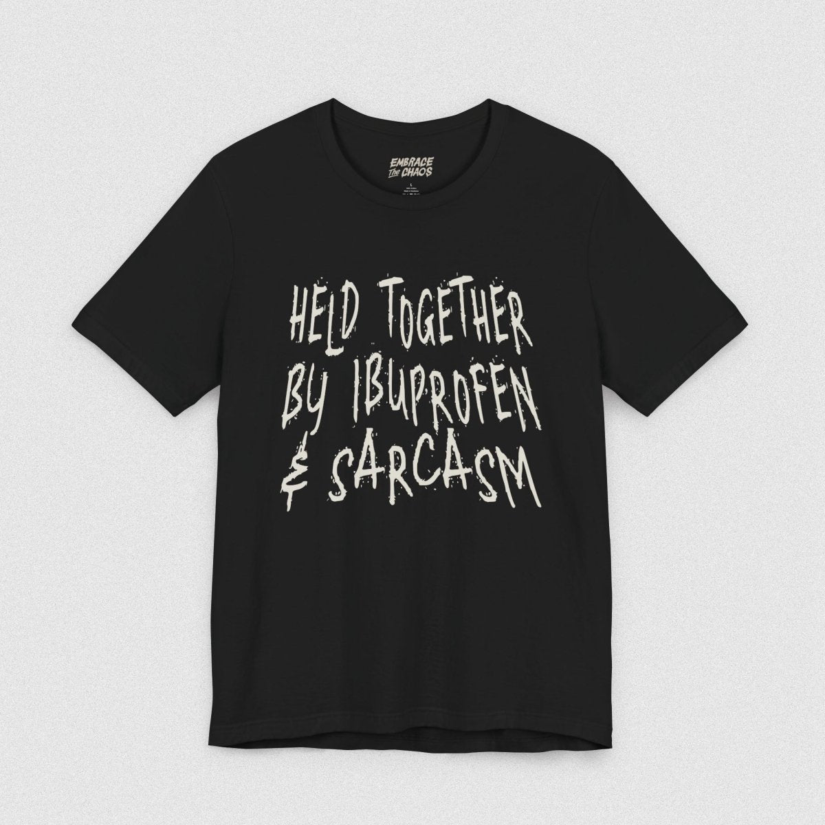 HELD TOGETHER BY IBUPROFEN & SARCASM TEE XS Black - Embrace The Chaos mental health humor apparel