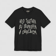 HELD TOGETHER BY IBUPROFEN & SARCASM TEE XS Black - Embrace The Chaos mental health humor apparel